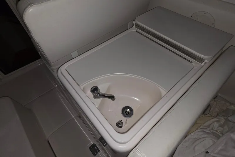Slide: The Image of 2005 Tiara 290 Coronet boat interior sink with closed lid and faucet. - 23