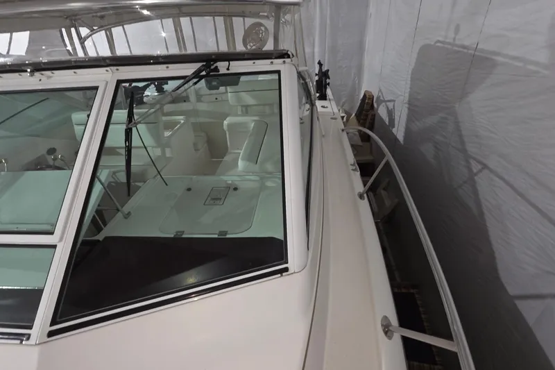 Slide: The Image of 2005 Tiara 290 Coronet boat interior with windshield and seating, in storage. - 27