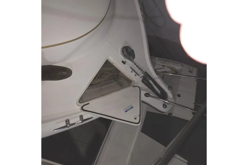 Slide: The Image of 2005 Tiara 290 Coronet boat interior with open storage compartment and visible ropes. - 28