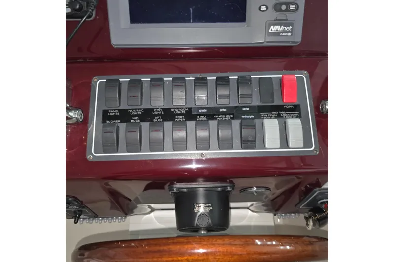 Slide: The Image of Control panel of a 2005 Tiara 290 Coronet boat with various switches and a display. - 3