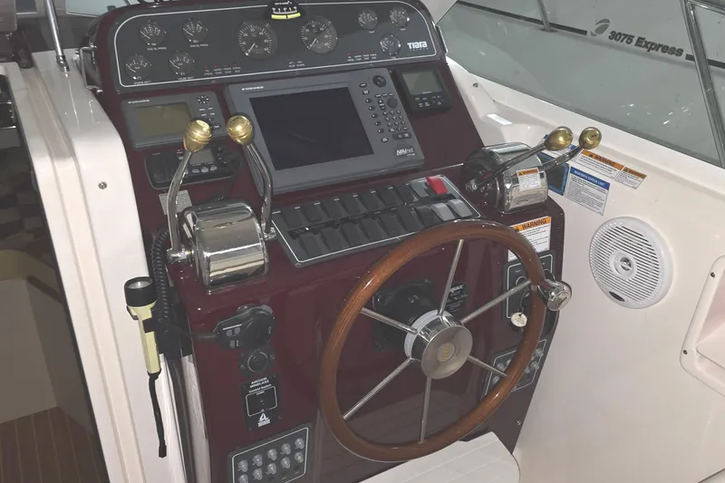 Slide: The Image of Helm of 2005 Tiara 290 Coronet boat with steering wheel and control panel. - 4
