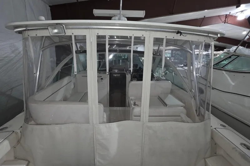Slide: The Image of 2005 Tiara 290 Coronet boat interior with clear enclosure in a storage facility. - 8