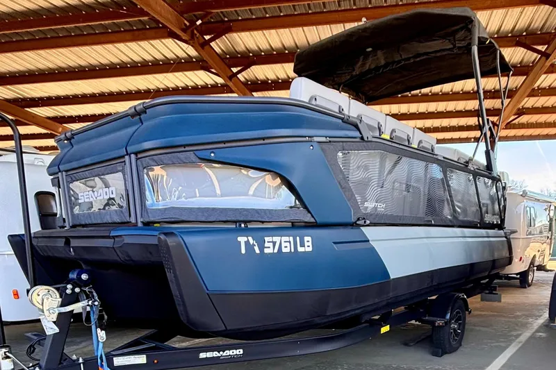 The Image of 2024 Sea-Doo Switch Cruise Limited 21 pontoon boat under a shelter. - 0