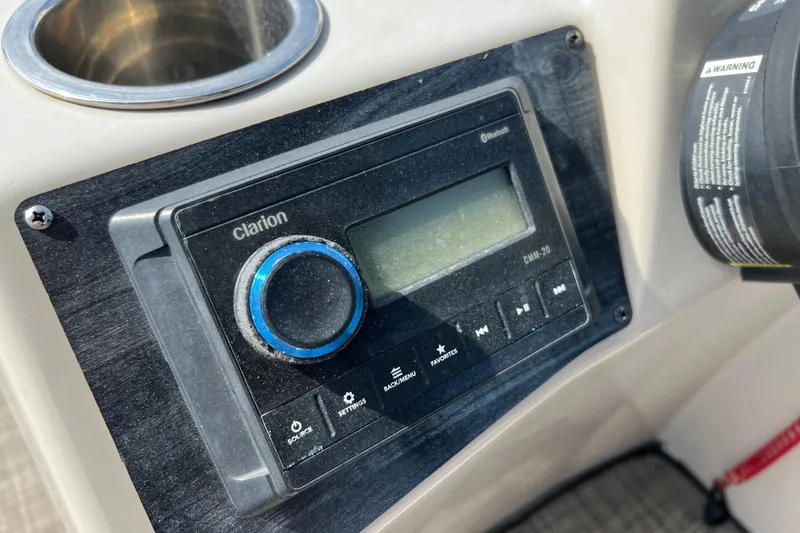 Slide: The Image of Clarion audio system on 2023 Harris Cruiser 230 boat dashboard. - 14