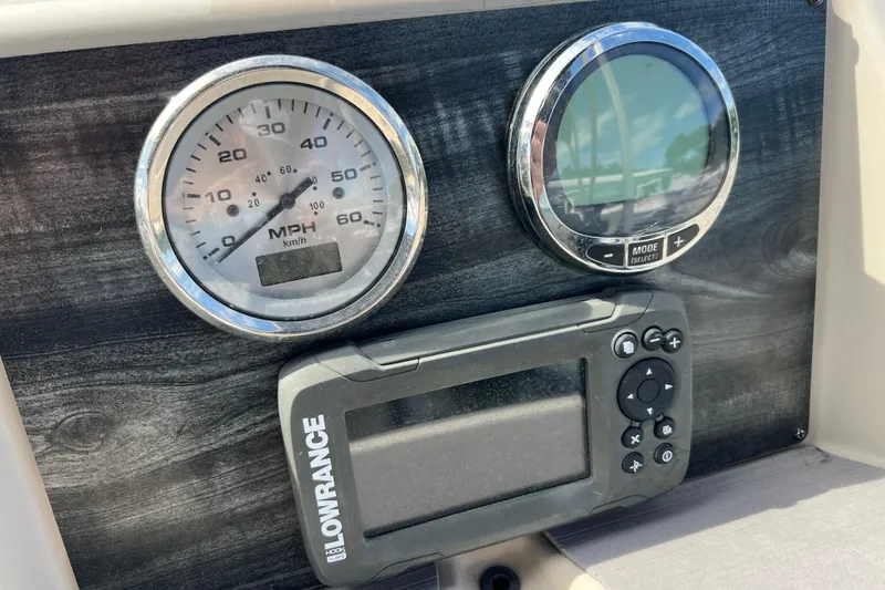 Slide: The Image of Dashboard of 2023 Harris Cruiser 230 with speedometer and Lowrance device. - 15