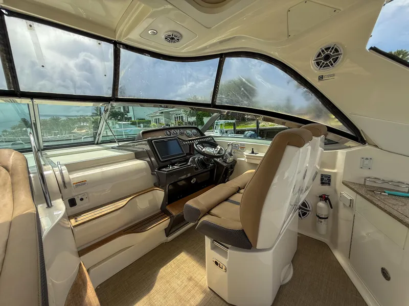 Slide: The Image of Interior of 2016 Sea Ray 350 Sundancer boat with modern helm and seating. - 10