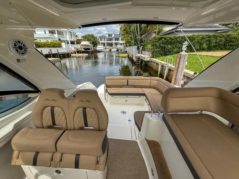 Slide: The Image of Interior view of 2016 Sea Ray 350 Sundancer yacht with luxurious seating and canal backdrop. - 13