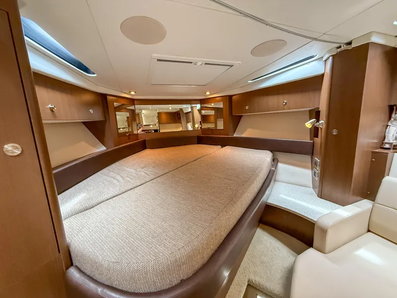 Slide: The Image of Luxurious interior of 2016 Sea Ray 350 Sundancer yacht with spacious bed and elegant wood finish. - 20
