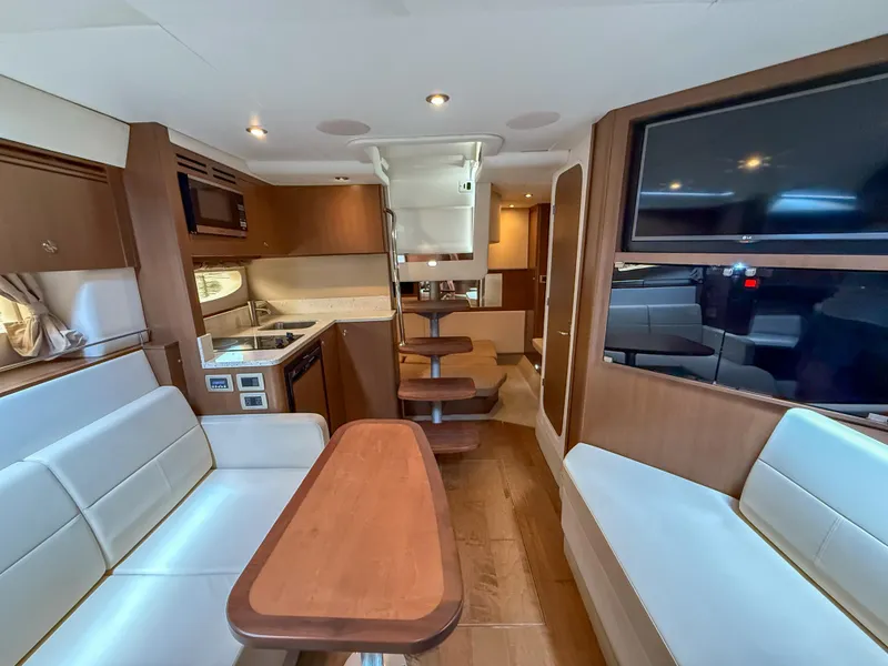 Slide: The Image of Interior of 2016 Sea Ray 350 Sundancer yacht with modern kitchen and seating area. - 22