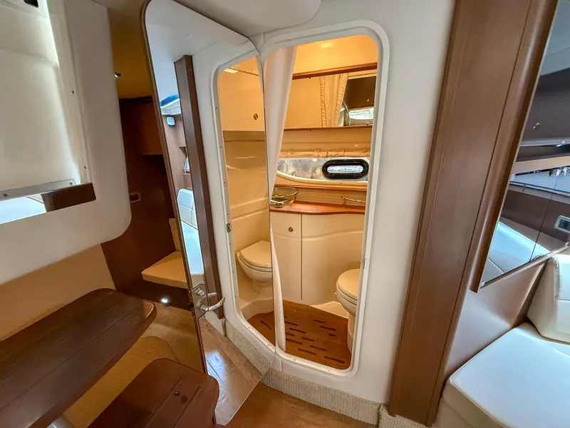 Slide: The Image of Interior of 2016 Sea Ray 350 Sundancer yacht, featuring a compact bathroom. - 24