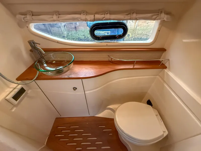 Slide: The Image of Luxurious bathroom in 2016 Sea Ray 350 Sundancer yacht with modern fixtures and wooden accents. - 27