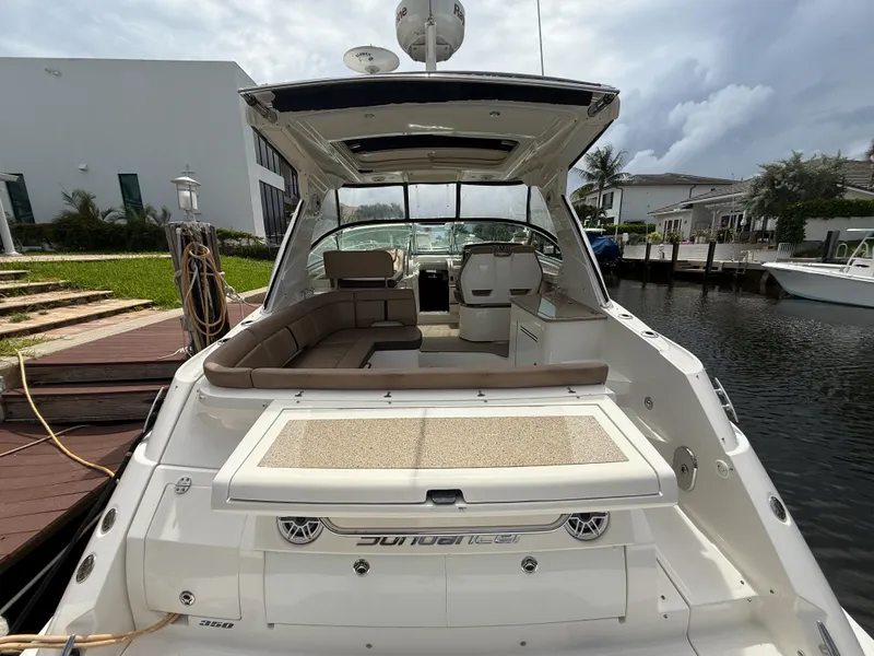 Slide: The Image of 2016 Sea Ray 350 Sundancer yacht docked, featuring spacious seating and sleek design. - 3