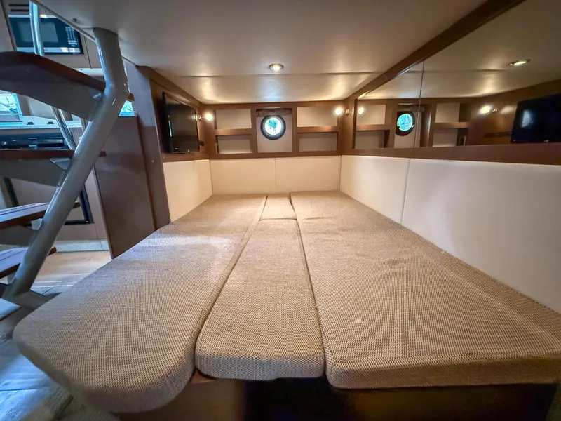 Slide: The Image of Interior cabin of 2016 Sea Ray 350 Sundancer yacht with cozy seating and porthole windows. - 31