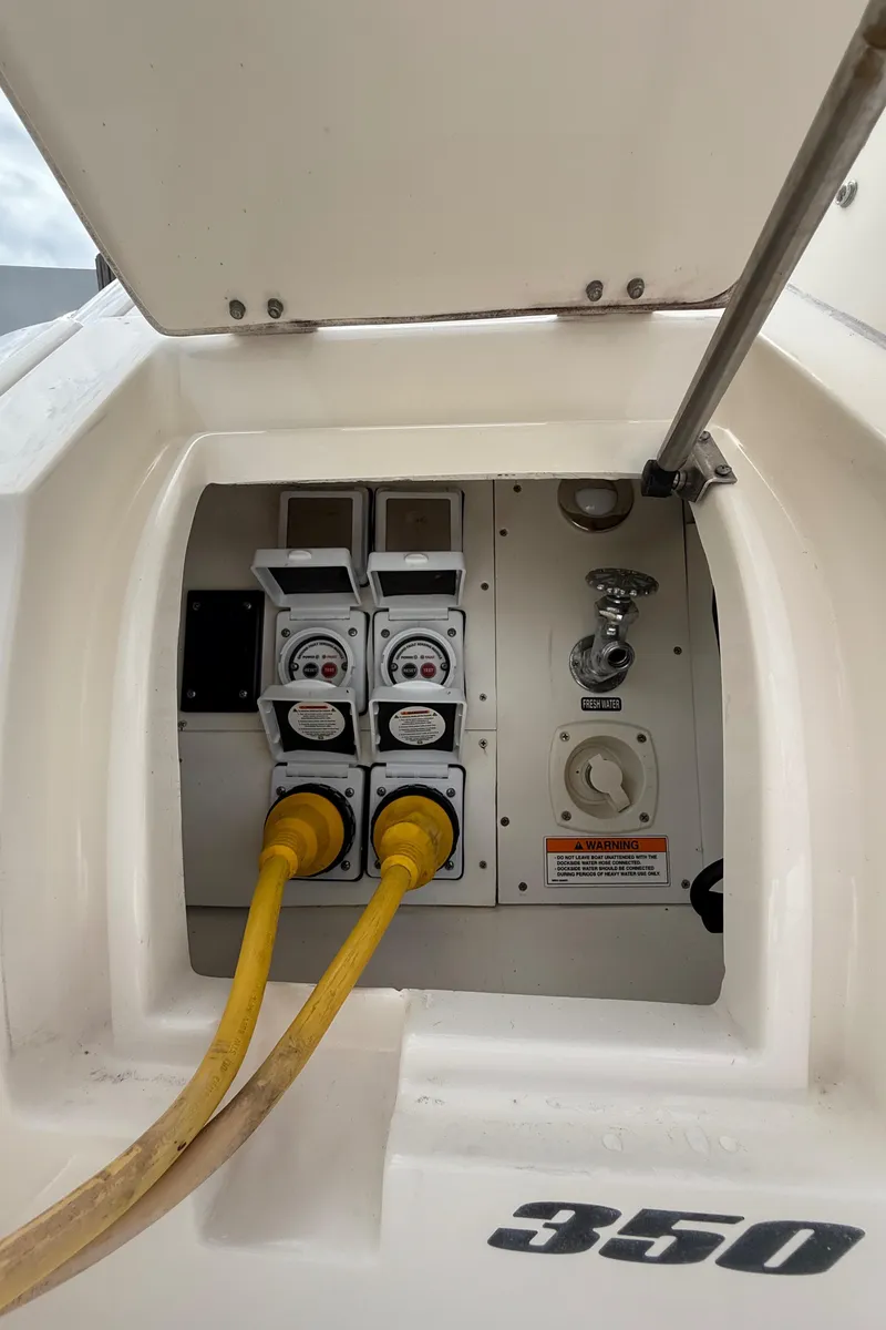 Slide: The Image of Electrical panel of 2016 Sea Ray 350 Sundancer with yellow power cables connected. - 40