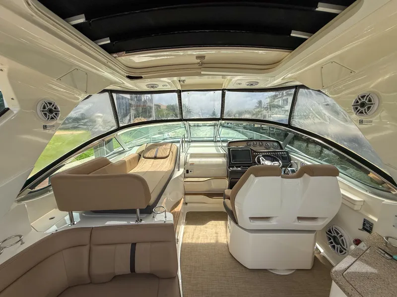 Slide: The Image of Interior of 2016 Sea Ray 350 Sundancer yacht with luxurious seating and modern dashboard. - 8