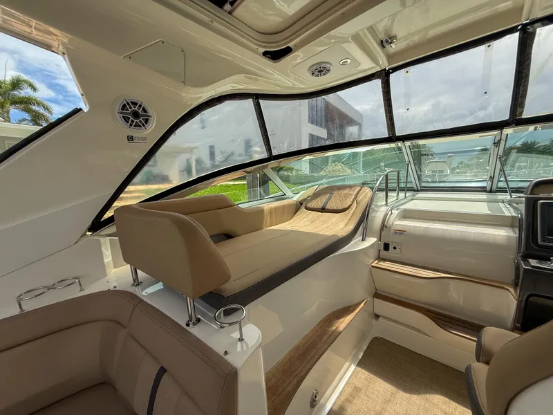 Slide: The Image of Interior of 2016 Sea Ray 350 Sundancer yacht with luxurious seating and panoramic windows. - 9