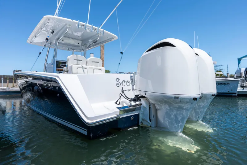 Slide: The Image of 2013 Jupiter 34 FS boat with dual engines docked in clear water. - 1