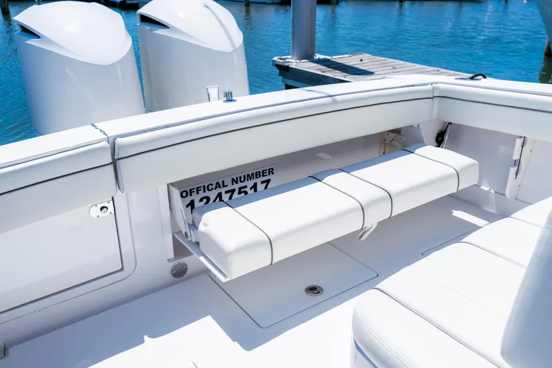 Slide: The Image of 2013 Jupiter 34 FS boat interior with white seating and visible official number. - 16