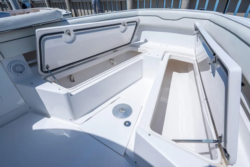Slide: The Image of 2013 Jupiter 34 FS boat storage compartments open, showcasing spacious interior design. - 19