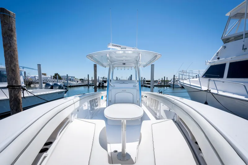 Slide: The Image of 2013 Jupiter 34 FS boat docked at marina under clear blue sky. - 20
