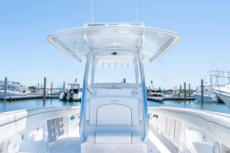 Slide: The Image of 2013 Jupiter 34 FS boat at marina, featuring sleek design and advanced Garmin equipment. - 21