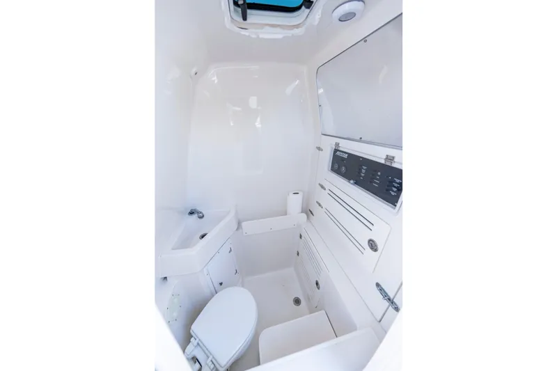 Slide: The Image of 2013 Jupiter 34 FS boat interior bathroom with sink, toilet, and control panel. - 27