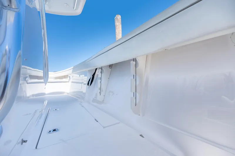 Slide: The Image of 2013 Jupiter 34 FS boat interior with sleek white design and blue sky background. - 28