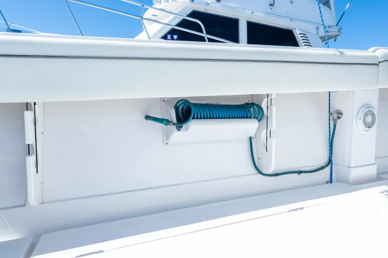 Slide: The Image of 2013 Jupiter 34 FS boat deck with coiled hose and storage compartment. - 29