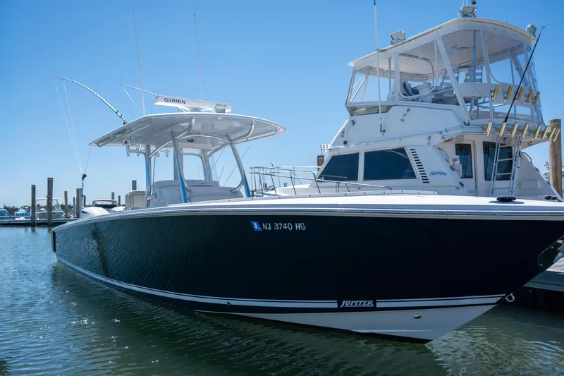 Slide: The Image of 2013 Jupiter 34 FS boat docked in marina, clear blue sky background. - 3