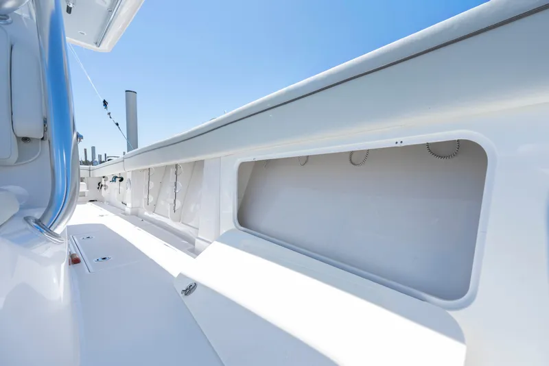Slide: The Image of 2013 Jupiter 34 FS boat interior with sleek white design and storage compartments. - 30