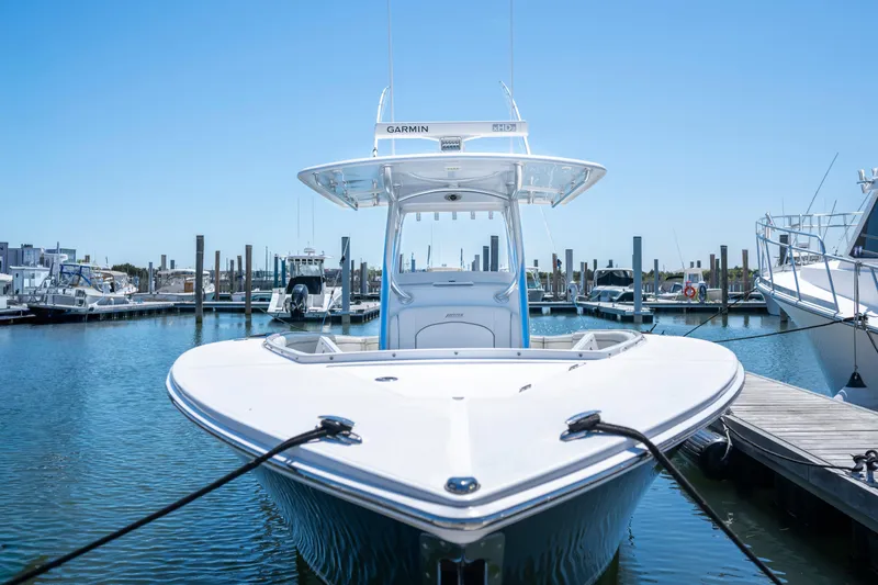 Slide: The Image of 2013 Jupiter 34 FS boat docked in marina, clear blue sky background. - 4