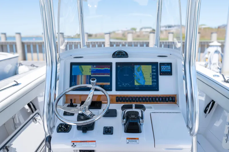 Slide: The Image of Helm of 2013 Jupiter 34 FS boat with navigation screens and controls. - 6