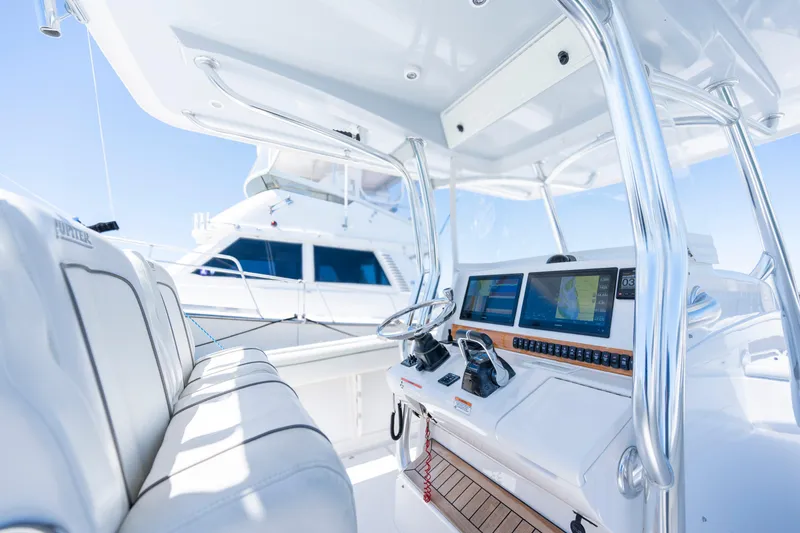 Slide: The Image of 2013 Jupiter 34 FS boat cockpit with modern navigation system and sleek design. - 7
