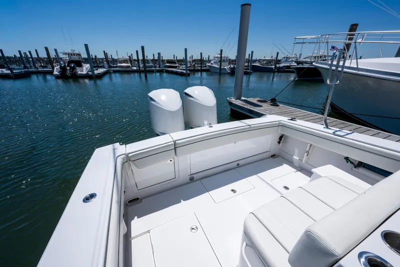 Slide: The Image of 2013 Jupiter 34 FS boat docked at marina with twin engines. - 9
