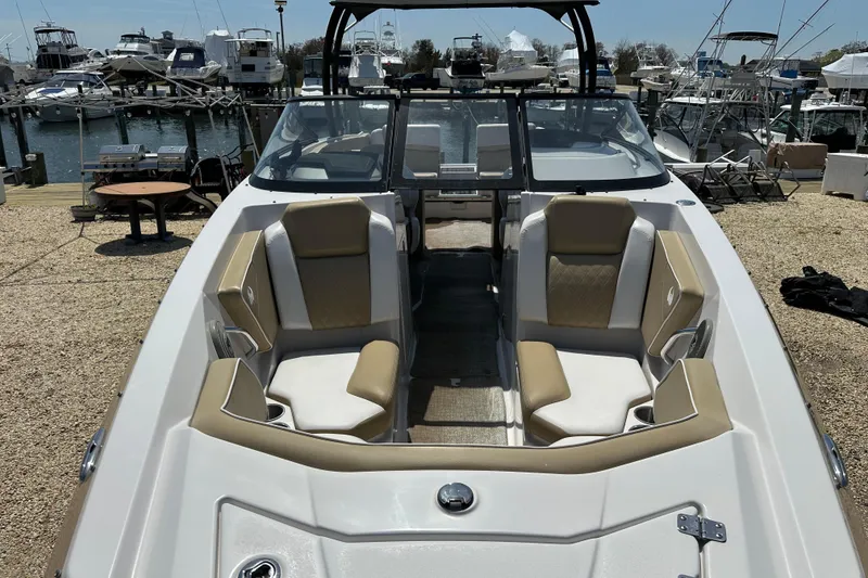 Slide: The Image of 2016 Scarab 255 H.O. Platinum boat with beige seating, docked at a marina. - 10