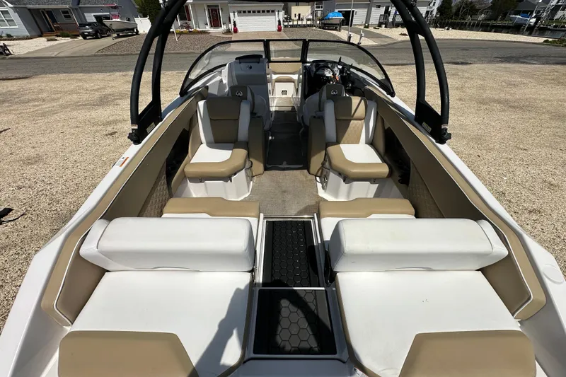Slide: The Image of 2016 Scarab 255 H.O. Platinum boat interior with beige and white seating. - 20