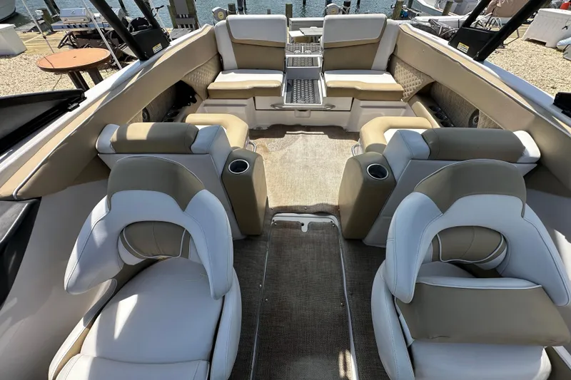 Slide: The Image of Interior of 2016 Scarab 255 H.O. Platinum boat with beige and white seating. - 23