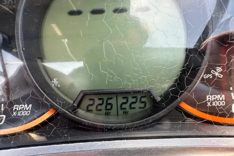 Slide: The Image of Close-up of a 2016 Scarab 255 H.O. Platinum boat's cracked dashboard display showing 226 hours. - 25