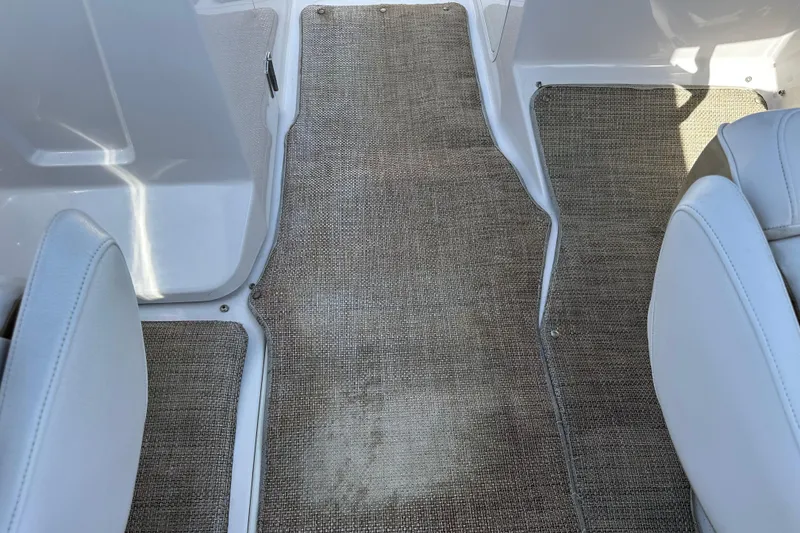 Slide: The Image of Interior view of 2016 Scarab 255 H.O. Platinum boat with beige carpet flooring. - 26