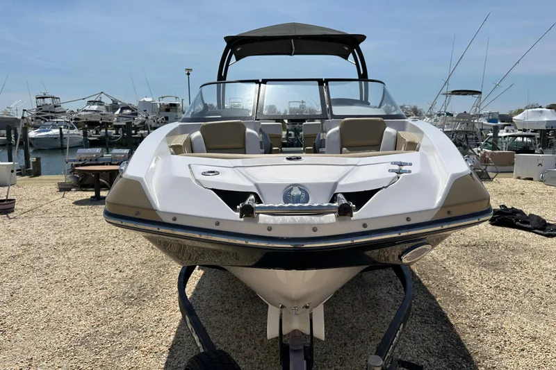 Slide: The Image of 2016 Scarab 255 H.O. Platinum boat on trailer at marina, sunny day. - 4