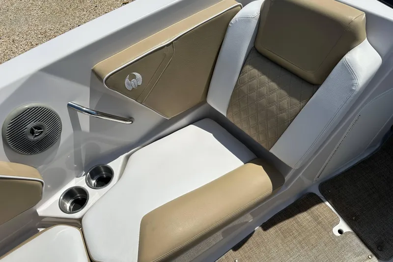 Slide: The Image of 2016 Scarab 255 H.O. Platinum boat interior with beige and white seating, cup holders, and speaker. - 9
