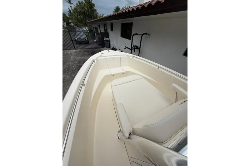Slide: The Image of 2013 Scout 210 XSF boat interior with beige seating and sleek design. - 10