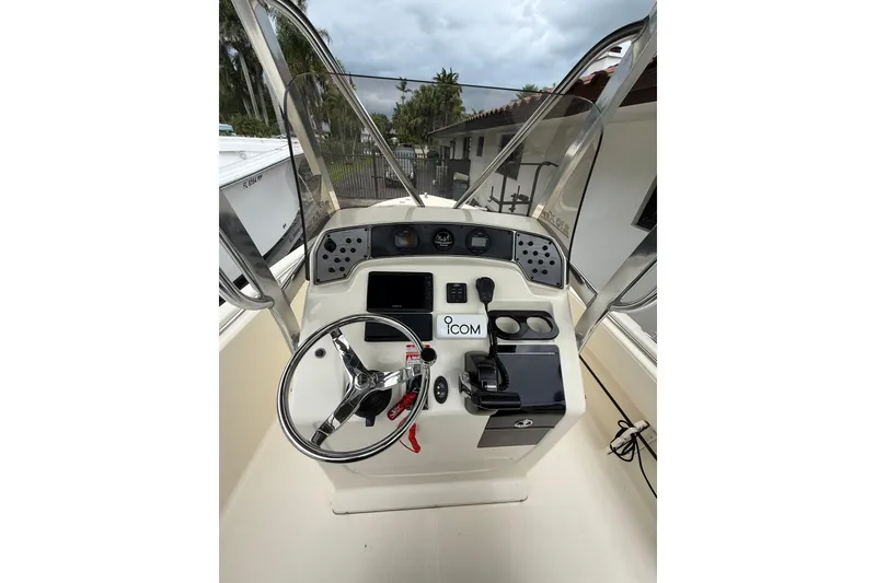 Slide: The Image of 2013 Scout 210 XSF boat dashboard with steering wheel and navigation controls. - 9
