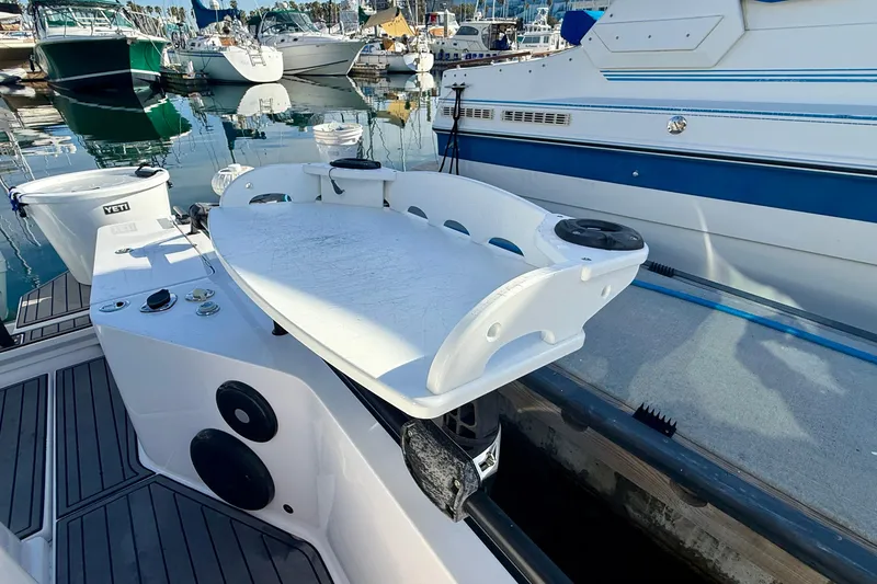 Slide: The Image of 2021 Axopar Brabus 28 Cabin boat docked, featuring a sleek white deck and modern design. - 11