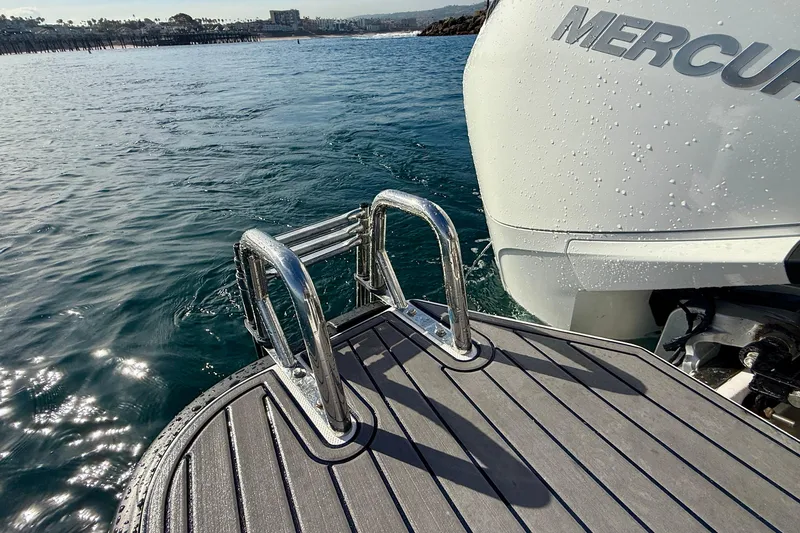 Slide: The Image of 2021 Axopar Brabus 28 Cabin boat with swim ladder and Mercury engine on water. - 23