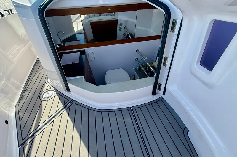 Slide: The Image of 2021 Axopar Brabus 28 Cabin interior with modern bathroom and sleek design. - 26