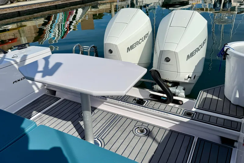 Slide: The Image of 2021 Axopar Brabus 28 Cabin with dual Mercury outboard engines and deck table. - 31