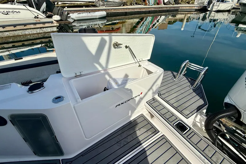 Slide: The Image of 2021 Axopar Brabus 28 Cabin boat with open storage compartment at marina. - 35