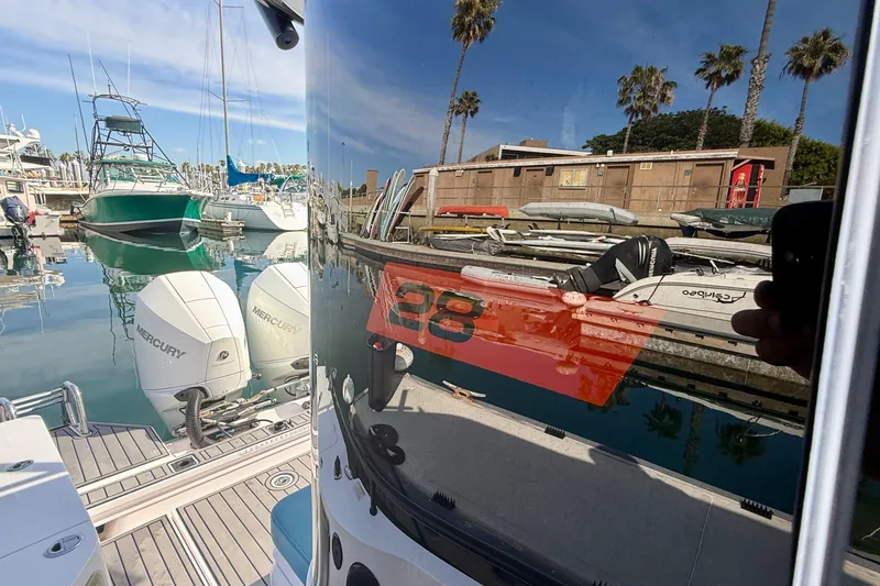 Slide: The Image of 2021 Axopar Brabus 28 Cabin reflected in marina with Mercury engines. - 38