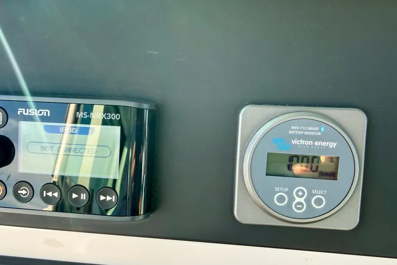 Slide: The Image of Control panel of 2021 Axopar Brabus 28 Cabin with Fusion and Victron Energy displays. - 49